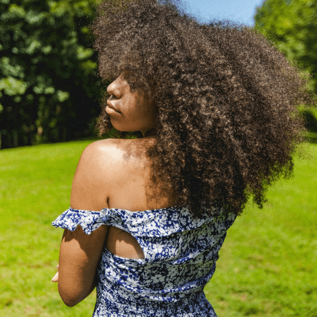 femme-aux-cheveux-crepus-naturels-soignes-avec-huile-pour-la-pousse-des-cheveux-crepus